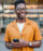 Man with orange shirt and phone