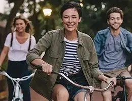 group of diverse young adults riding bikes