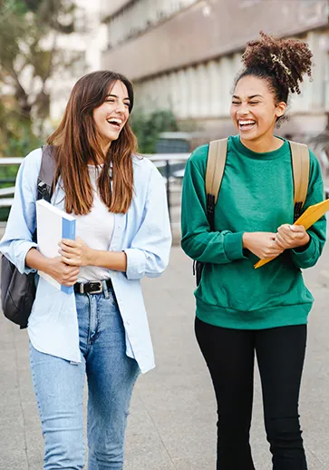 two young college students walking to class