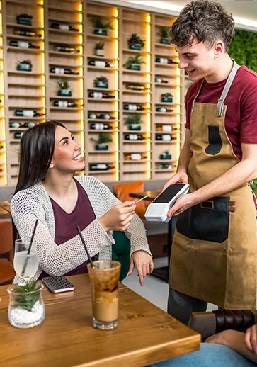 young woman paying a dinner bill
